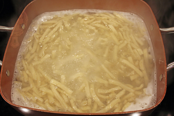 Pot with Reames Noodles boiling.