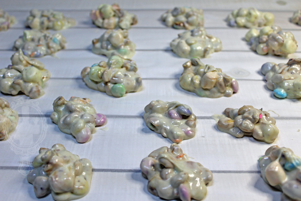 Clusters of Easter Crockpot Candy on parchment paper. Ready to set.