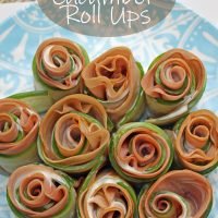 Overhead view of the cucumber roll ups on a blue plate.