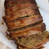 Meatloaf sliced on a white square plate, ready to serve.