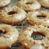Angled picture of banana bread donuts on a rack.