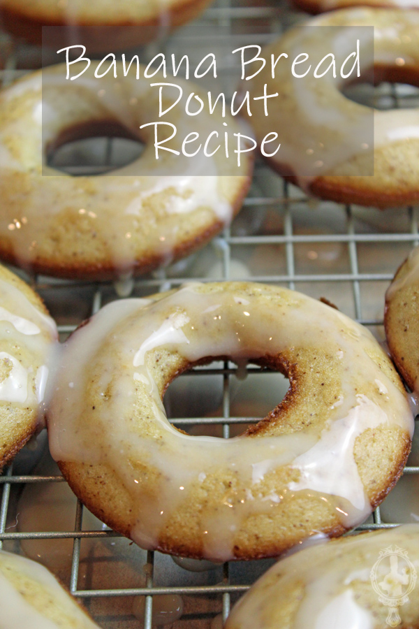 Overhead view of banana bread donuts with icing drizzled over them on a rack.
