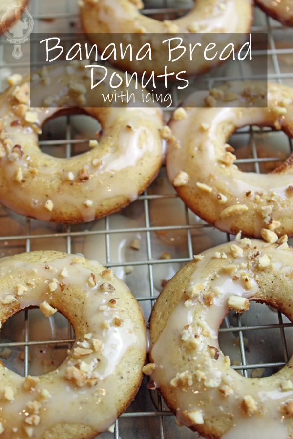 Overhead view of banana bread donuts on a rack with icing and nuts on top.