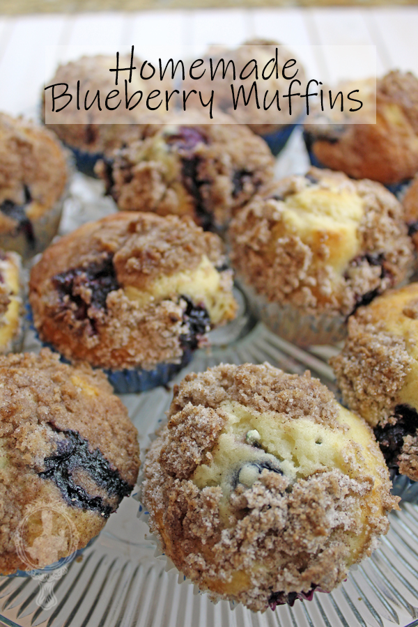 A serving platter with 12 blueberry muffins ready to scarf down.