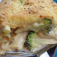 Close up image of a serving of Chicken Alfredo Crescent Bake on a plate ready to eat.
