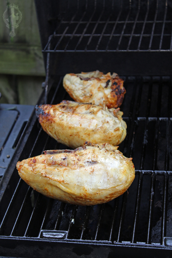 Chicken after being flipped during grilling process.