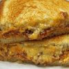 Close up of two halves of Sloppy Joe Grilled Cheese
