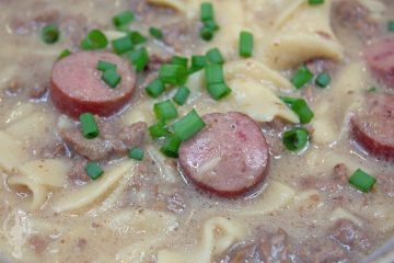 Very close up of Hamburger and Sausage Soup with chopped green onions on top.