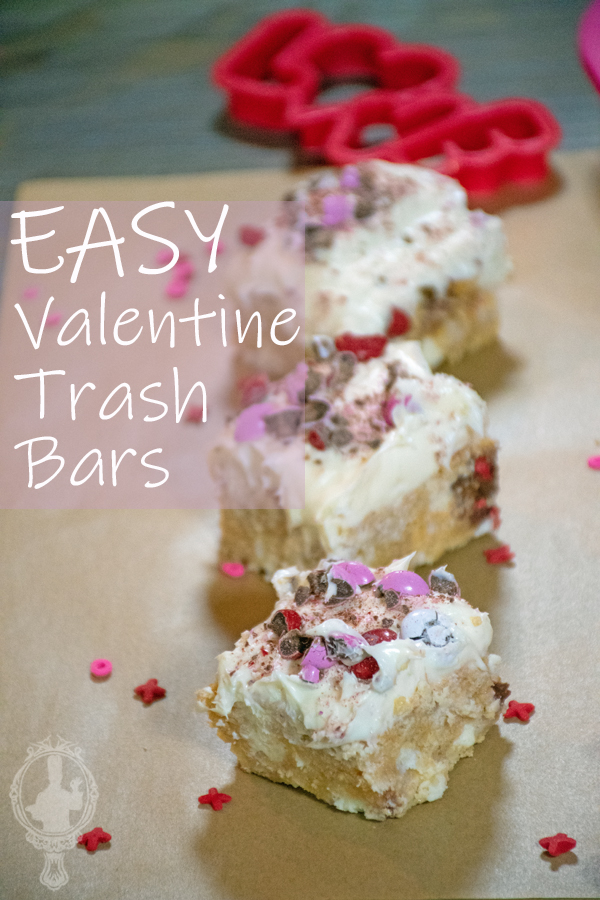 # Valenine trash bars lined up on parchment paper with sprinkles all around.