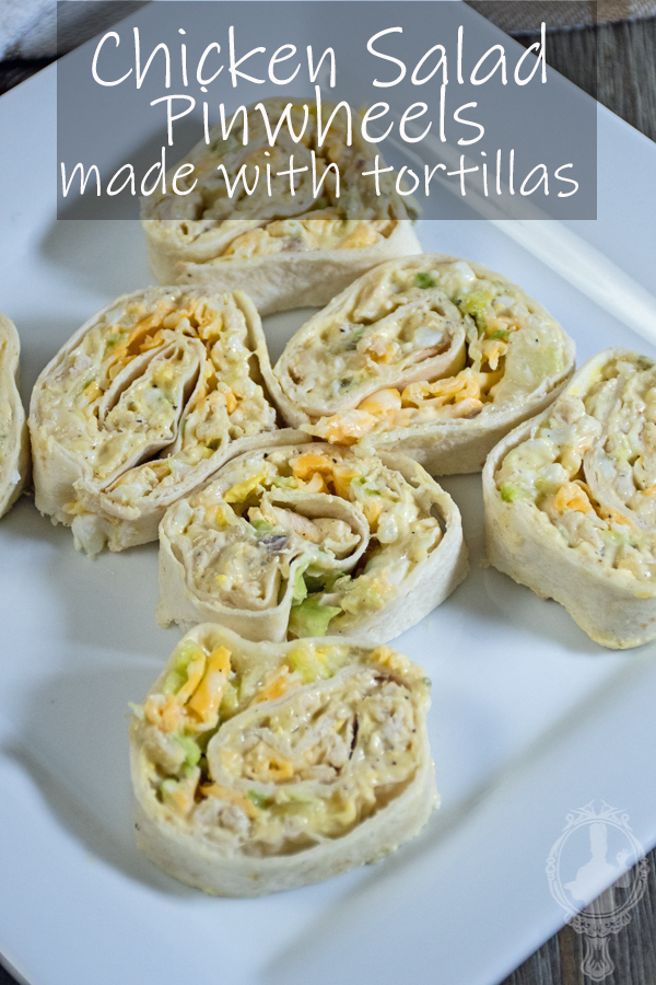 7 sliced chicken salad pinwheels on a white plate.