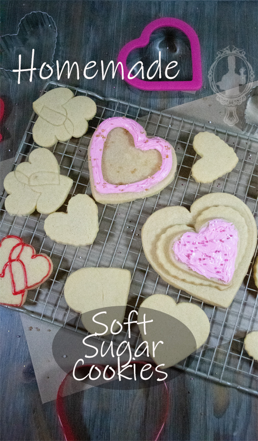 Overhead view of cut out soft sugar cookies on a cooling rack with a couple frosted.