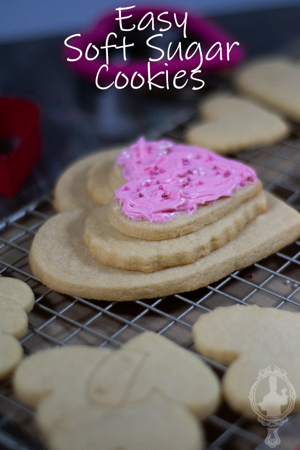 Side view of 3 heart cookies stacked on each other. The top one is frosted.