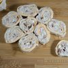 Sliced tuna salad pinwheels on a cutting board.
