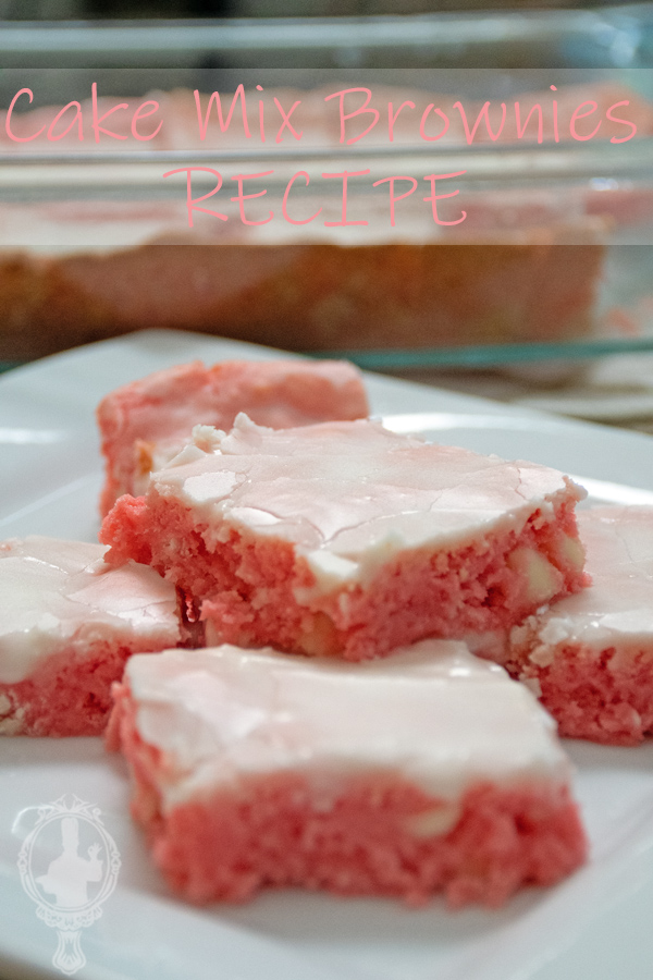 Straight on view of some cake mix brownies on a plate with the rest of the batch in a baking dish in the background.