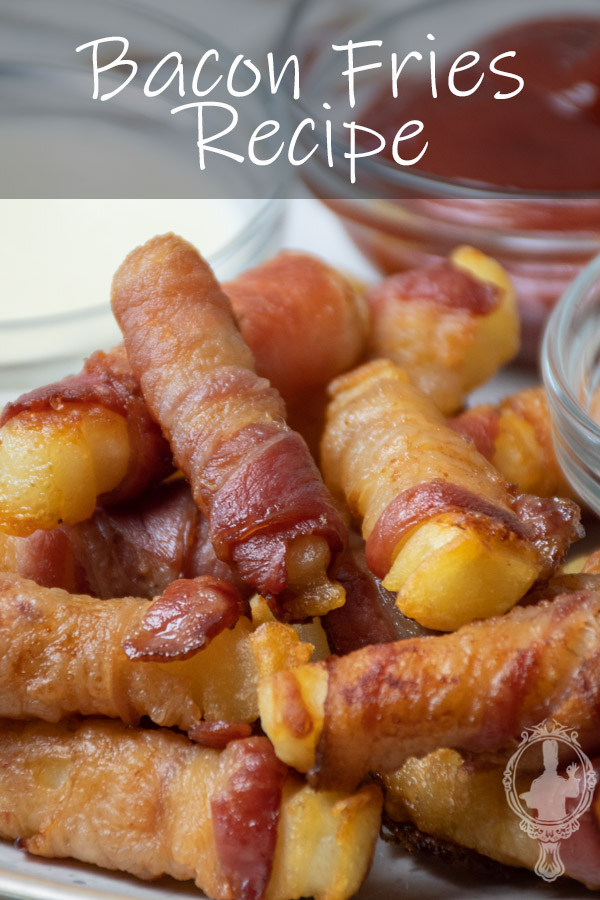 Close up of a serving of bacon fries with condiments on the side.