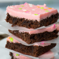 A stack of chocolate covered brownies.