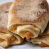 Close up of 3 peach roll ups.