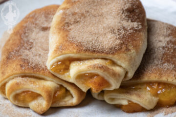 Close up of 3 peach roll ups.