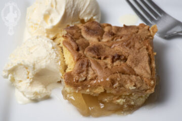 Overhead, close up view of a slice of apple cobbler cake.