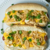 Overhead shot of two cheesy ranch dogs.