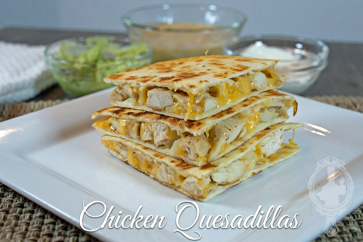 Chicken Quesadillas Direct view of a stack of chicken quesadillas on a white plate with extras in the background.