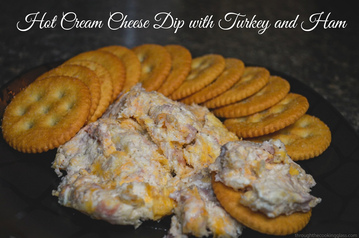 hot cream cheese dip A plate with crackers surrounding hot cream cheese dip